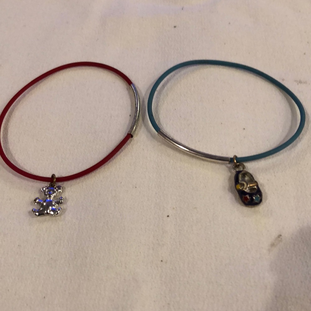 Handmade rubber bracelet, with a metal band and a  baby shoe trinket.